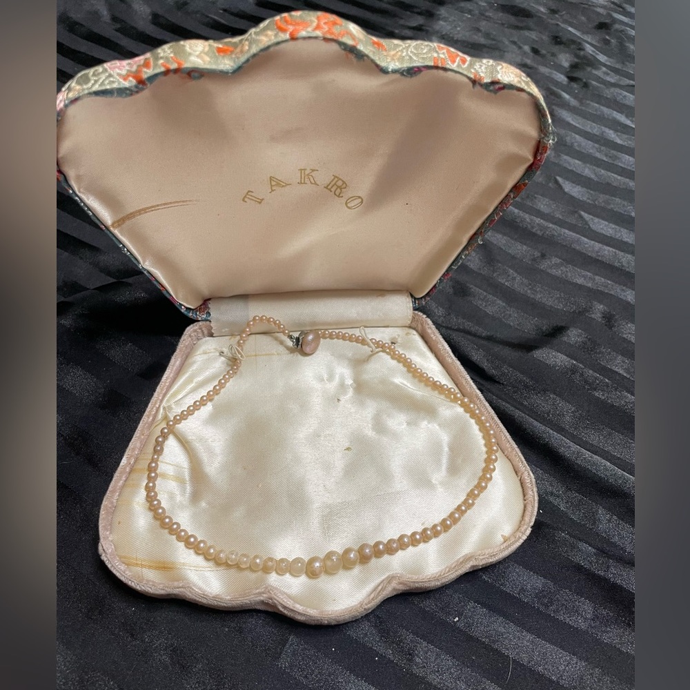 Vintage clamshell jewelry case with faux pearl necklace